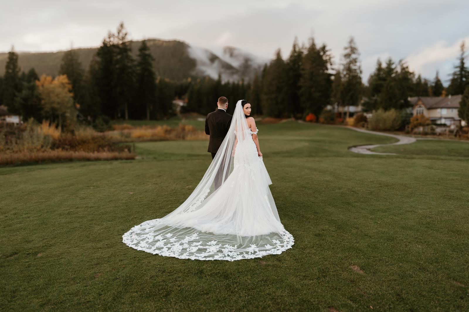 Bride with cathedral veil and mountain backdrop