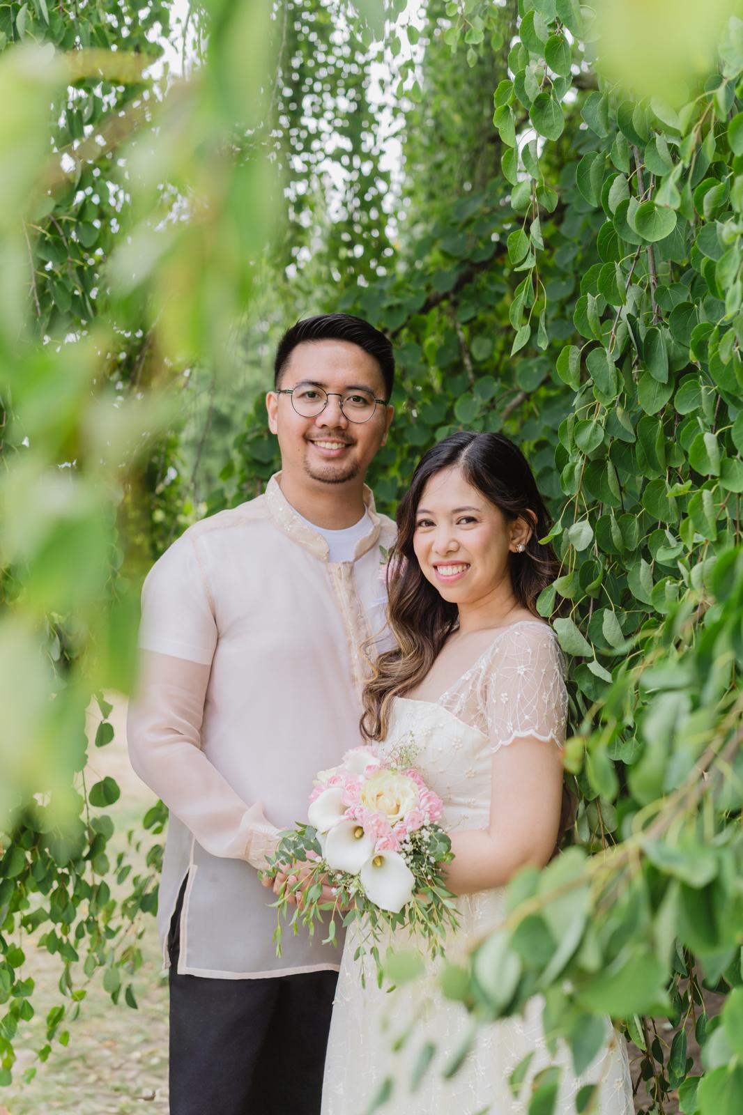 Couple beneath green vines