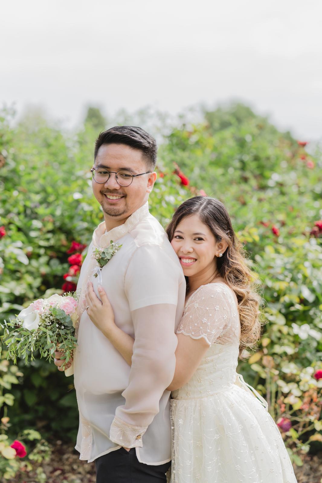 Couple embracing among rose bushes