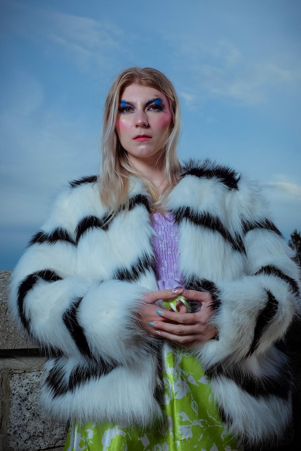 Editorial portrait in fur coat with blue brows