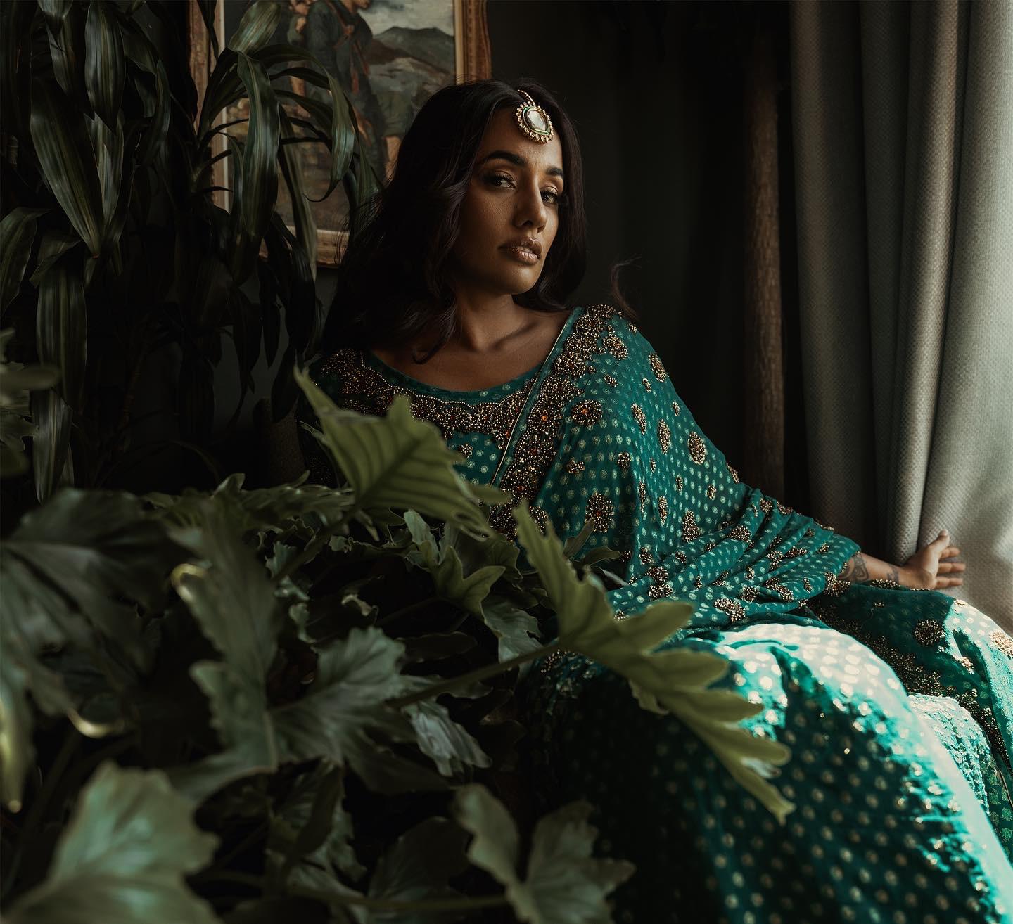 South Asian bride with maang tikka in green lehenga