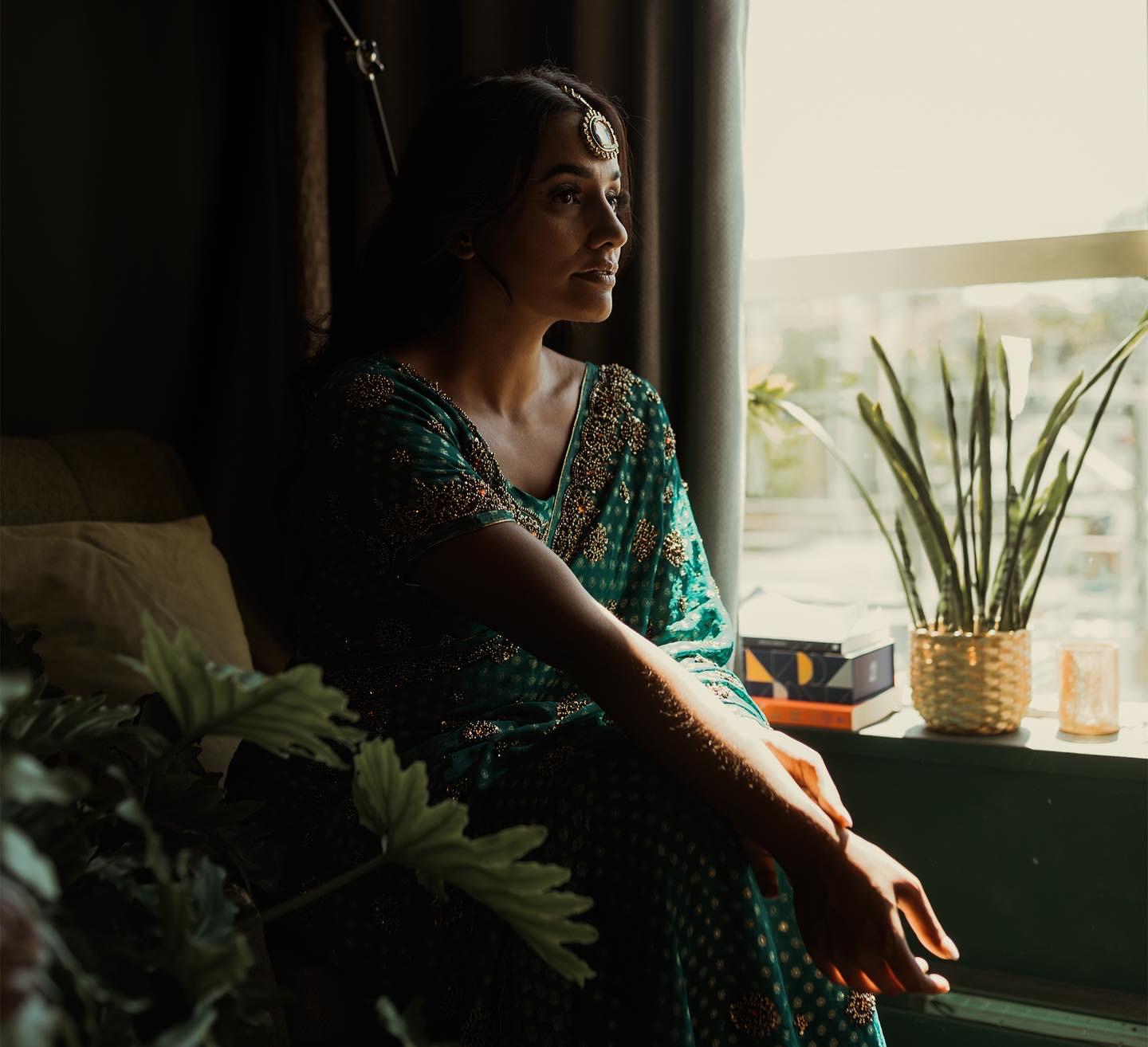 South Asian bride in window light